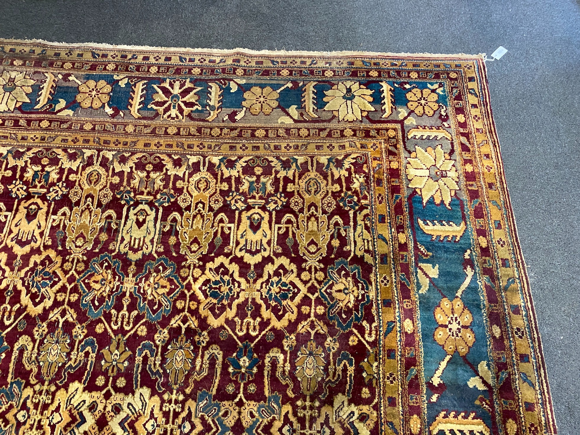 A large Sarouk purple ground carpet, approx. 20ft x 12ft. (cut in one area)